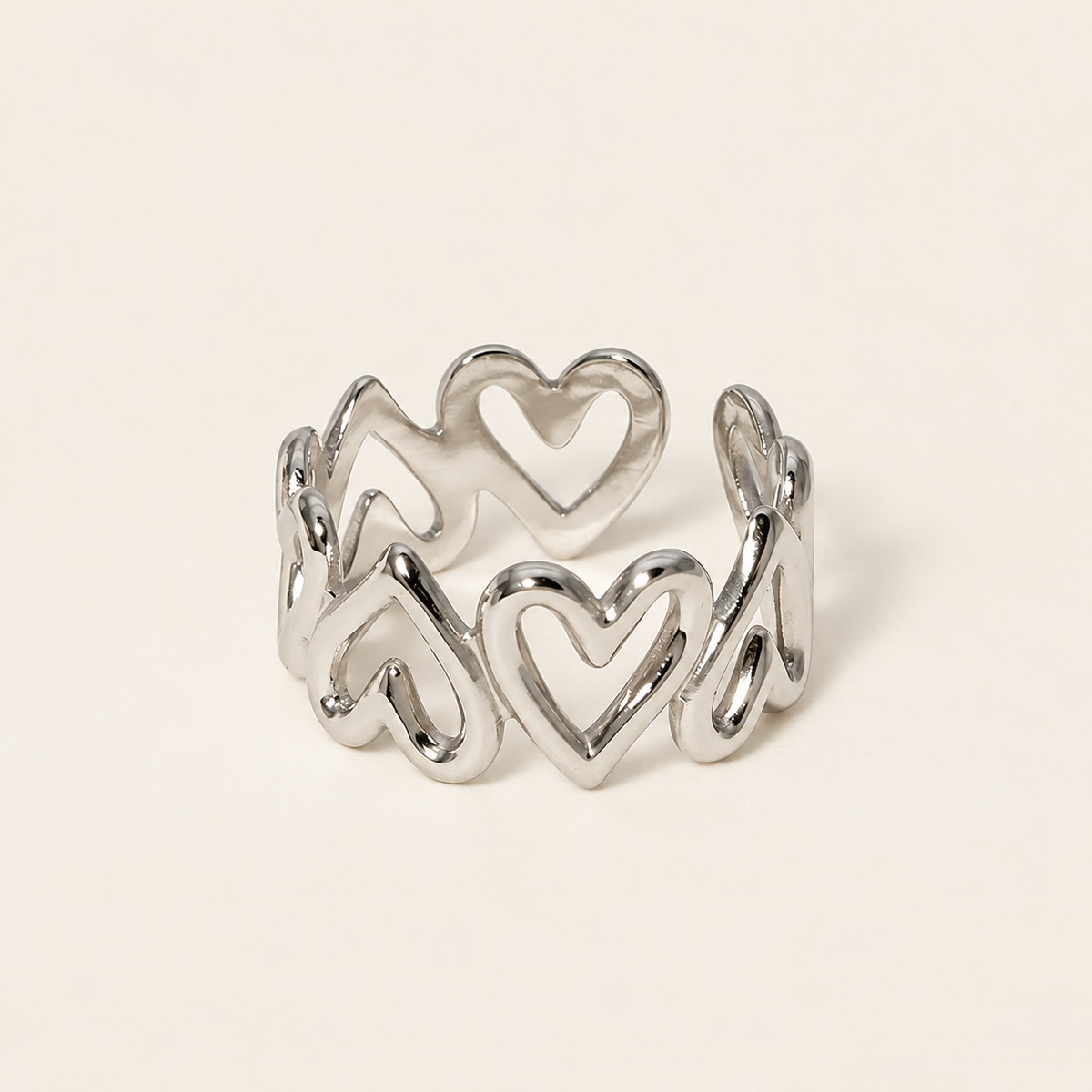 Silver Heart Band Ring — warm ivory background
