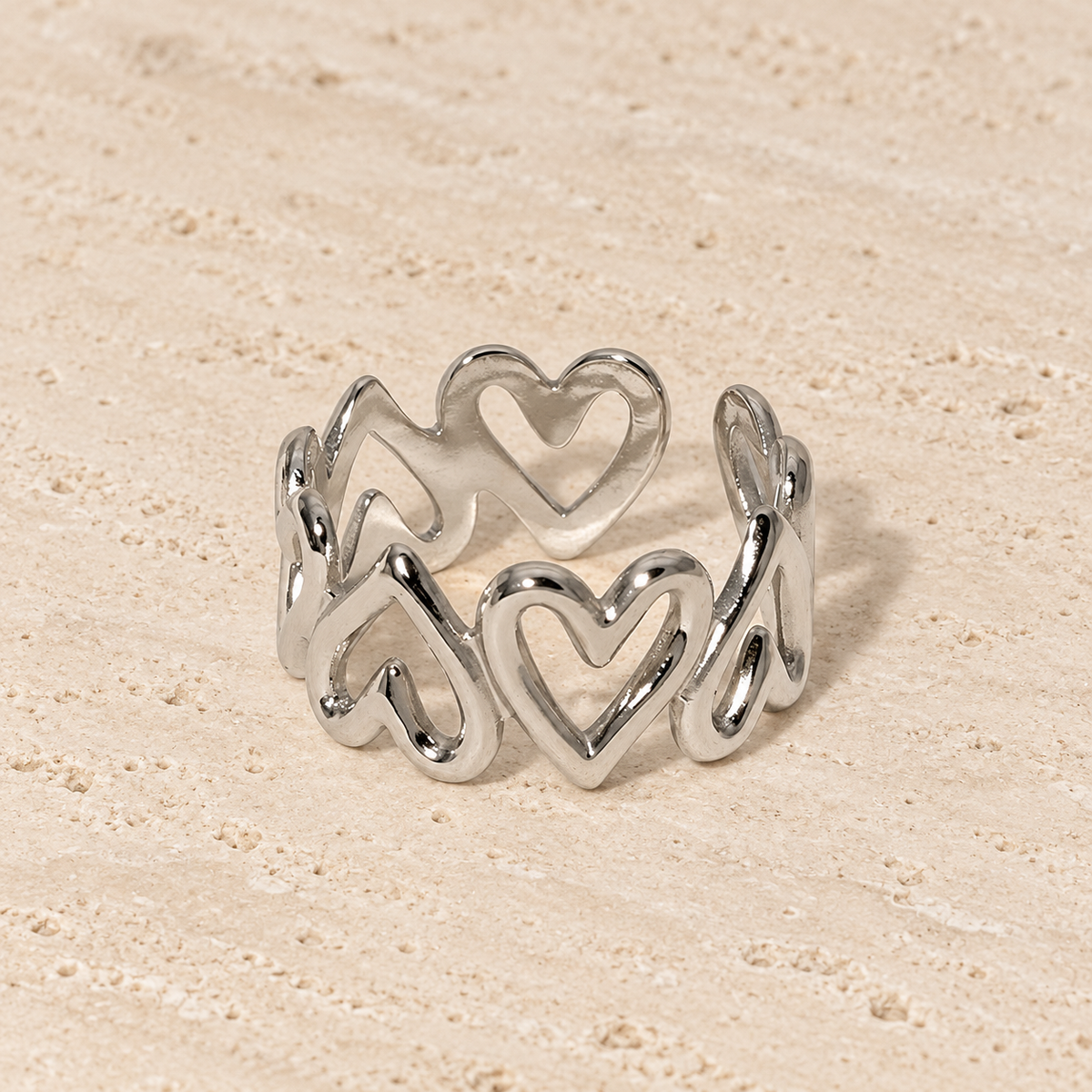 Silver Heart Band Ring — pale beige natural stone background