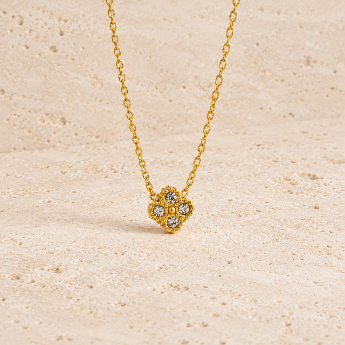 Crystal Flower Pendant Necklace — pale beige natural stone background