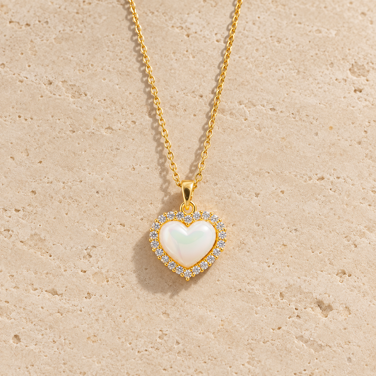 Pearlescent Heart Necklace — pale beige natural stone background