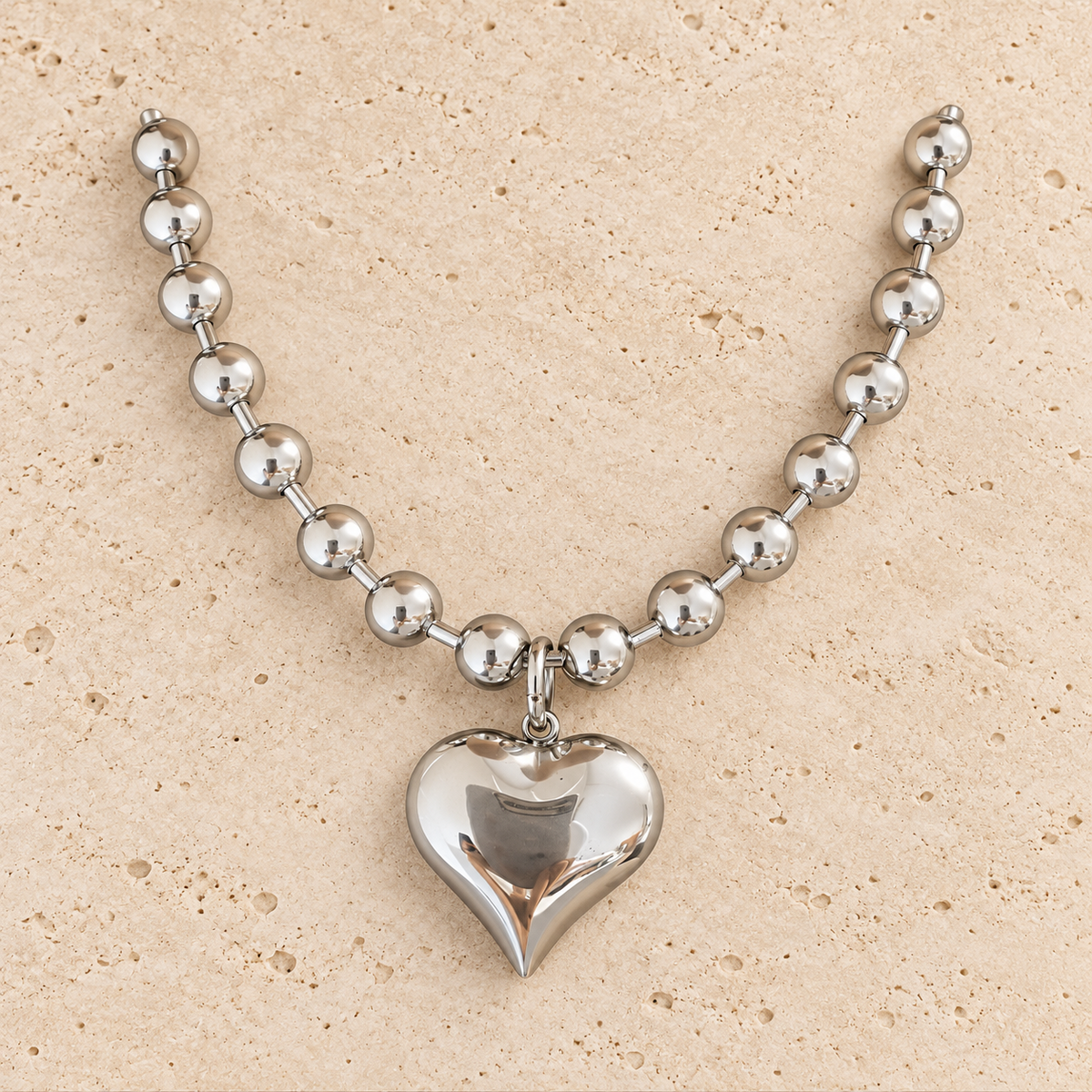 Silver Heart Ball Chain Necklace — pale beige natural stone background