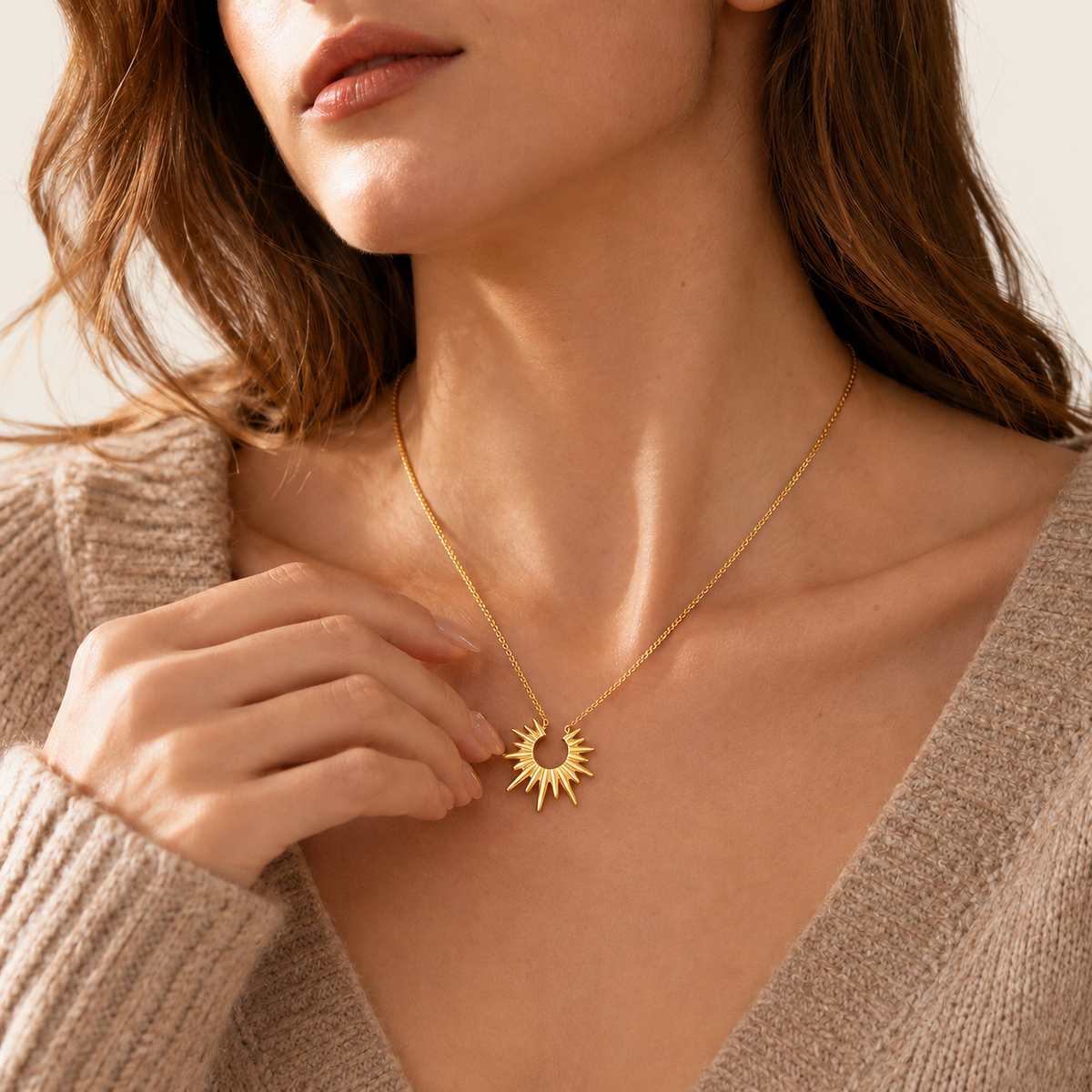 Gold Sun Pendant Necklace — warm ivory background