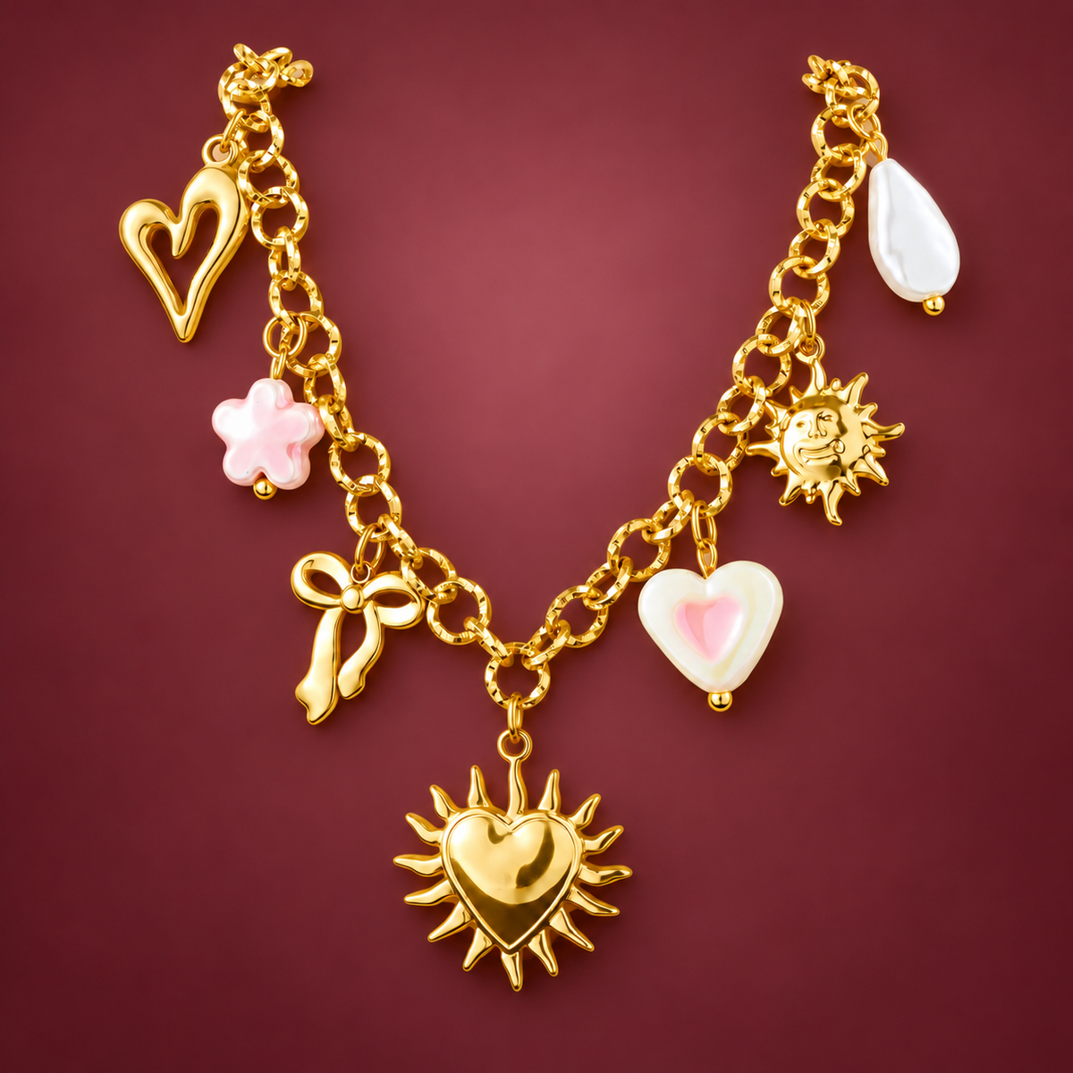 Gold-Tone Charm Chain Necklace — muted burgundy background