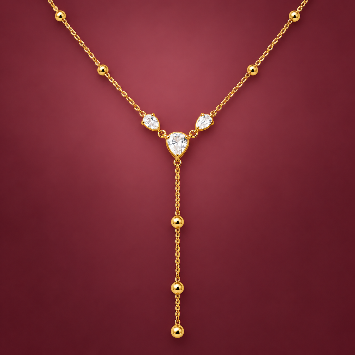 Crystal Heart Y Necklace — muted burgundy background