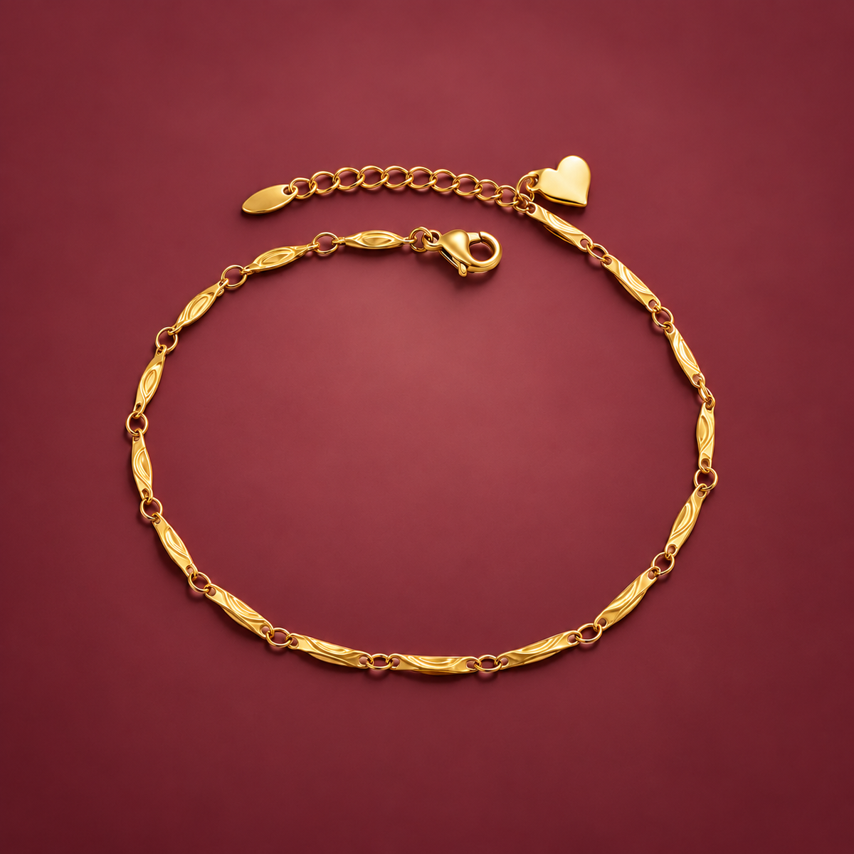Gold-Tone Heart Chain Anklet — muted burgundy background