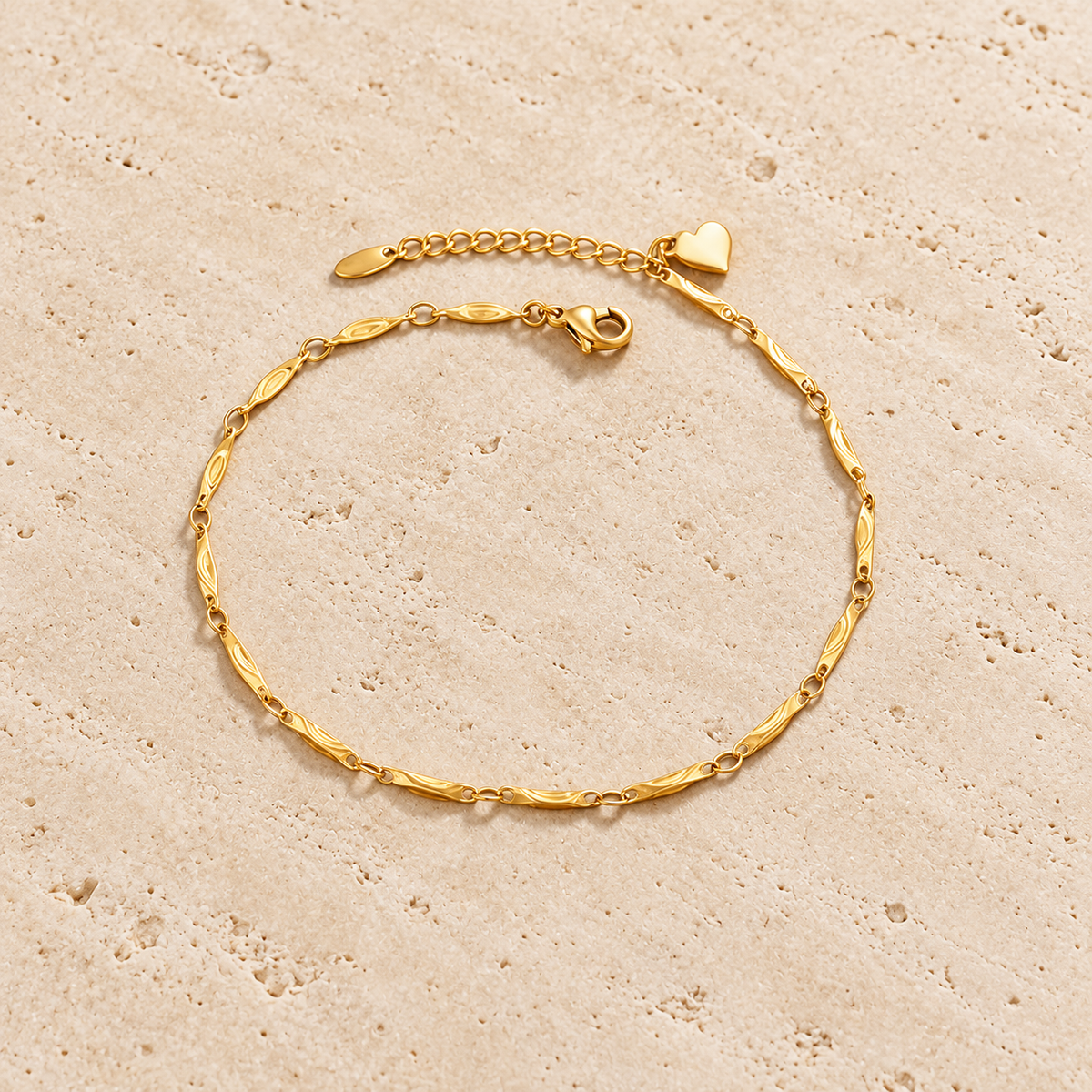 Gold Heart Chain Anklet — pale beige natural stone background