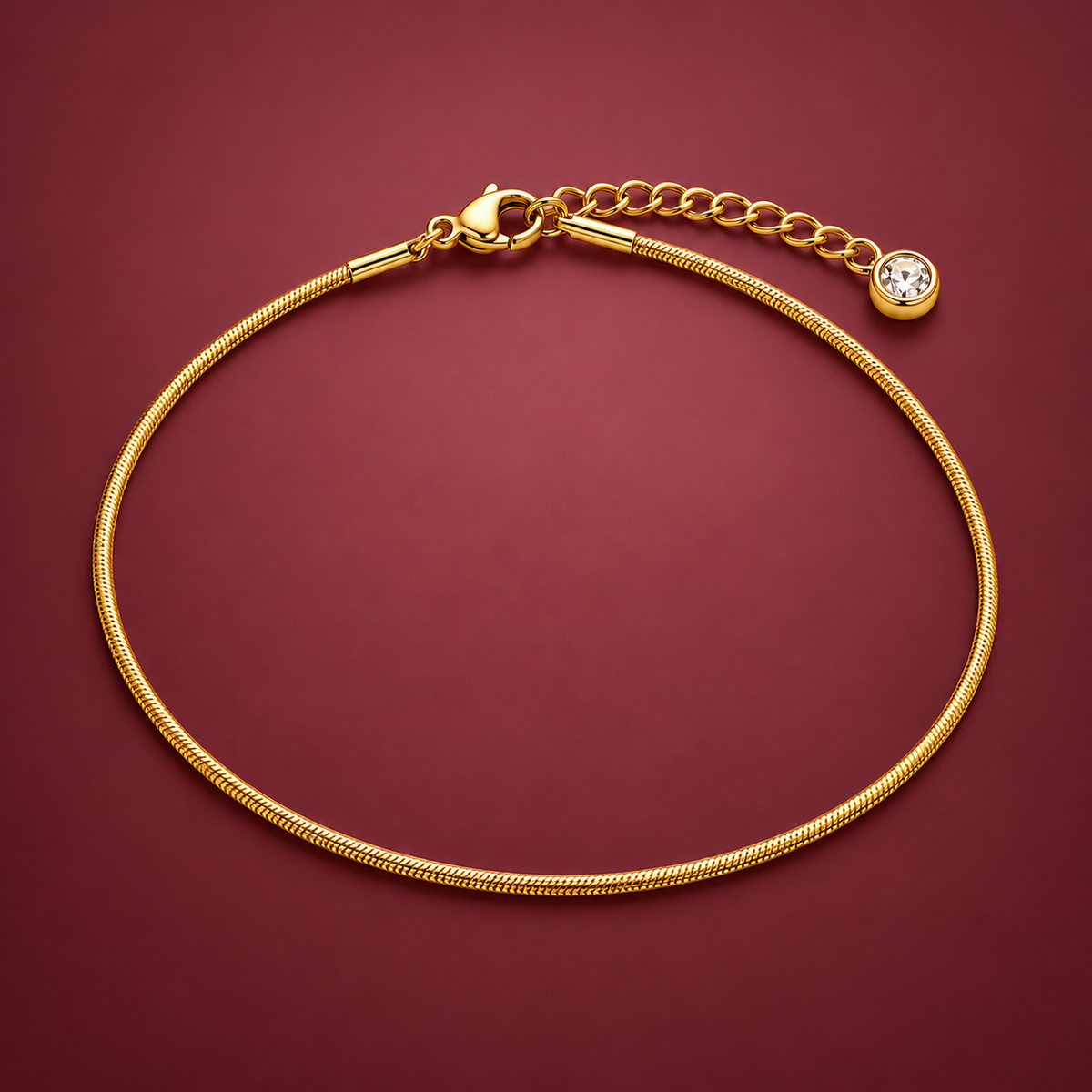 Gold-Tone Herringbone Anklet — muted burgundy background