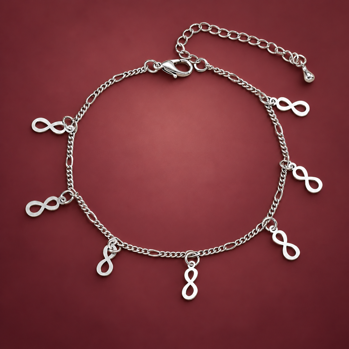 Silver-Tone Infinity Charm Anklet — muted burgundy background