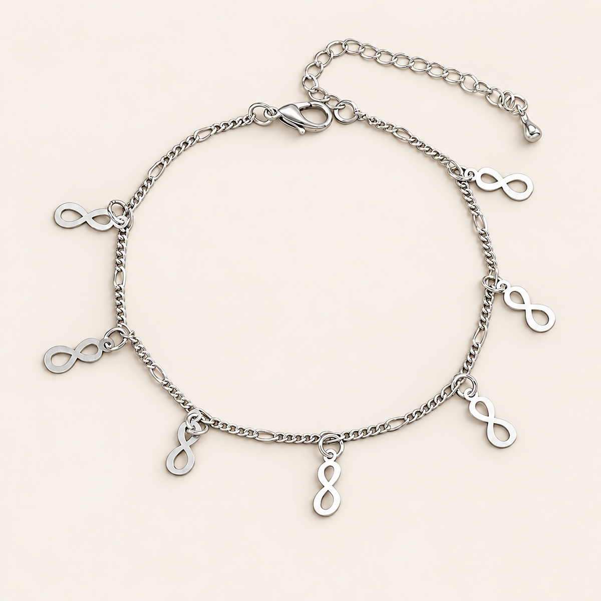 Silver Infinity Charm Anklet — warm ivory background