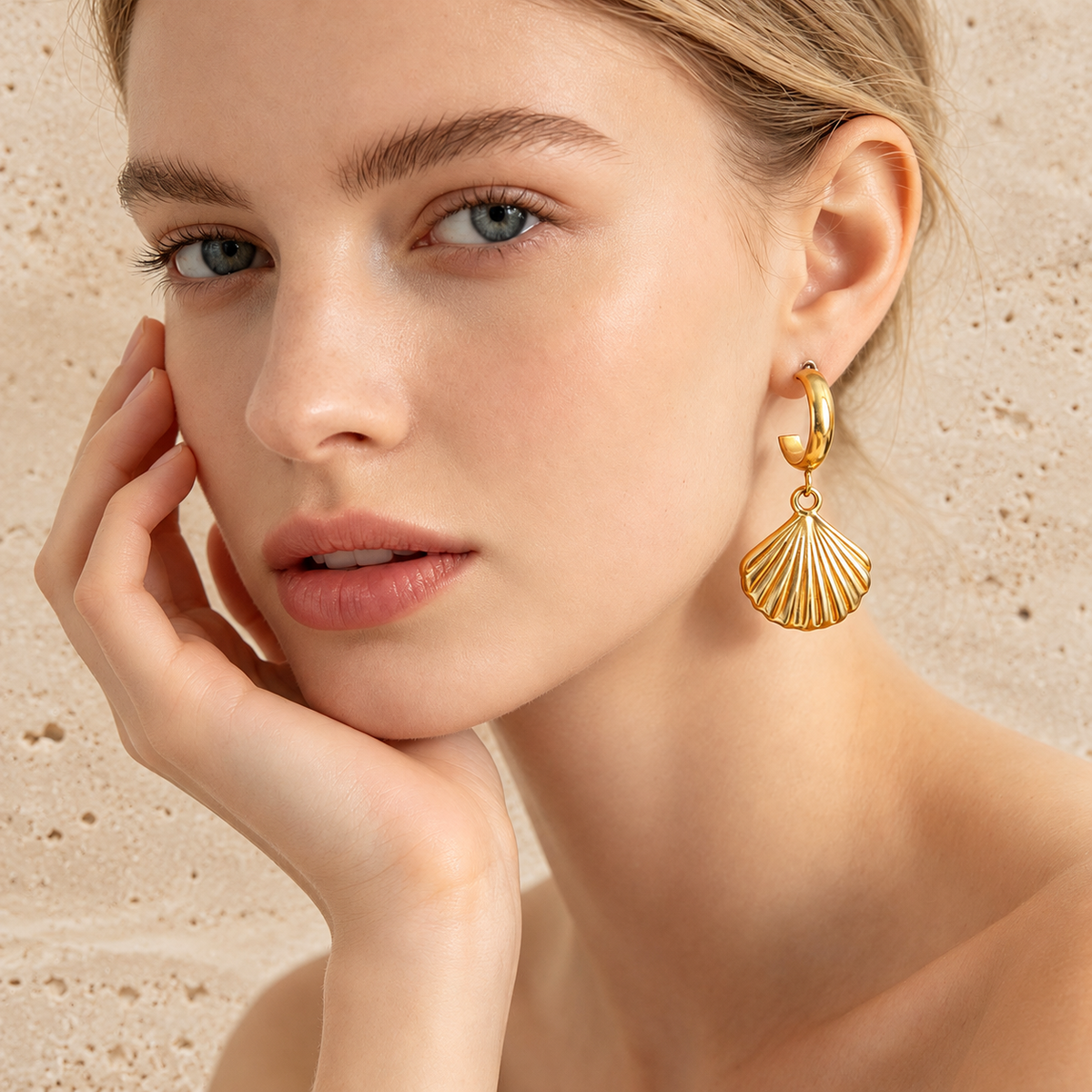 Gold Fan Shell Earring — pale beige natural stone background