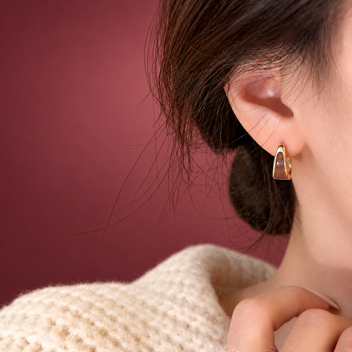 Gold-Tone Black Inlay Hoop Earring — muted burgundy background