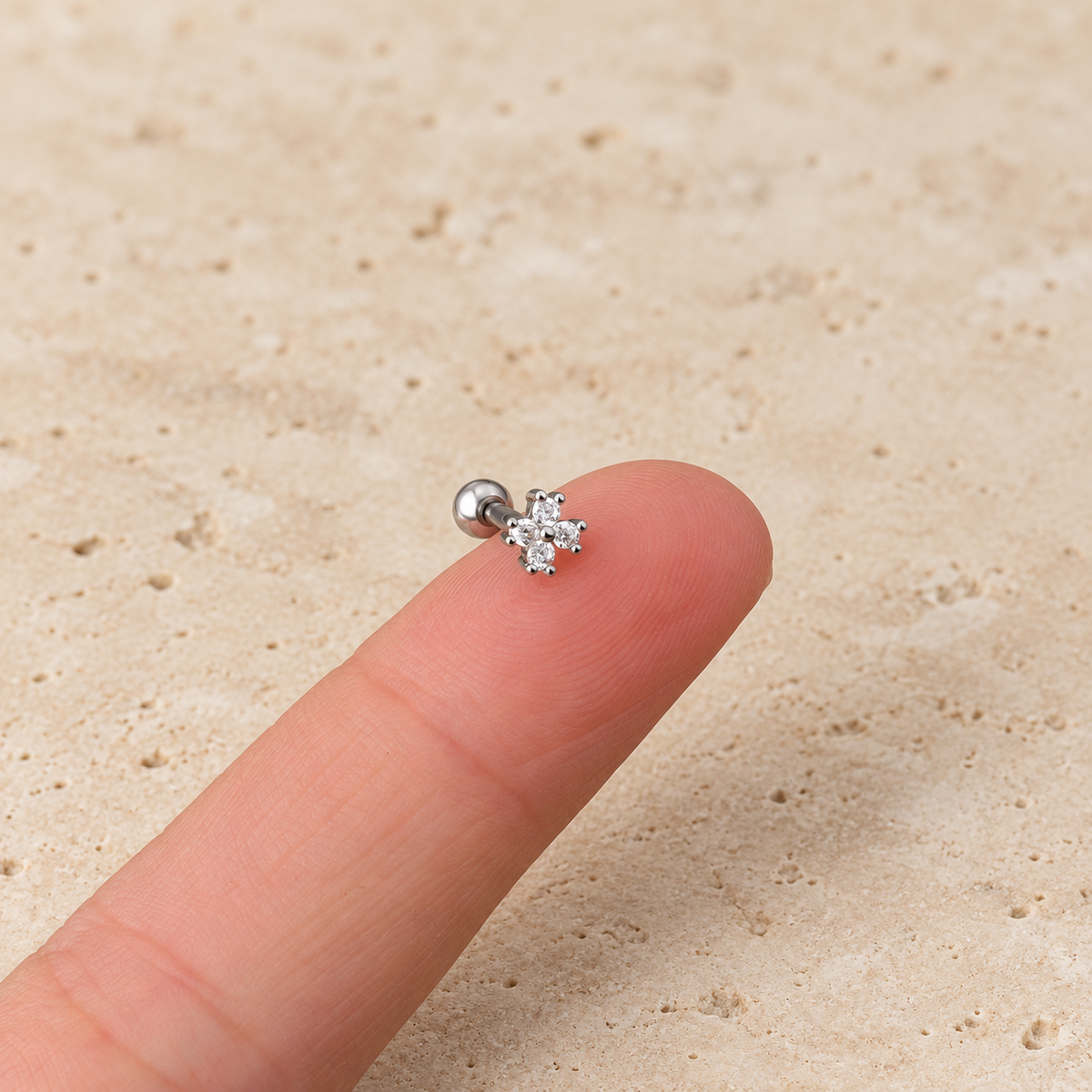 Silver Flower Cartilage Stud — pale beige natural stone background