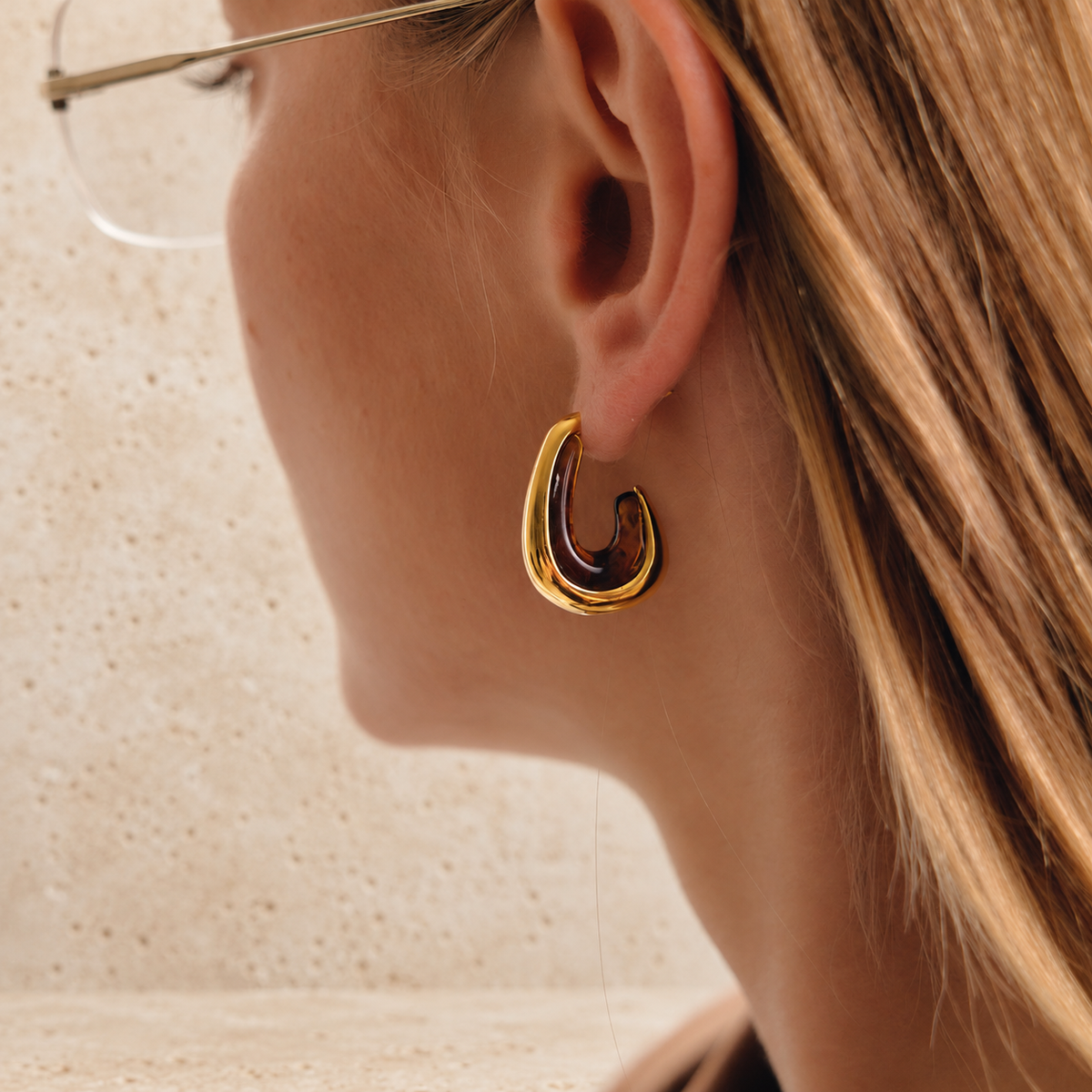 Gold Resin Hoop Earring — pale beige natural stone background