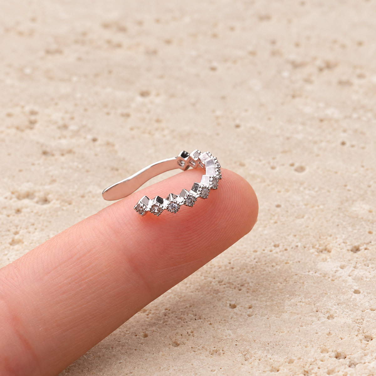 Crystal Curve Ear Cuff — pale beige natural stone background