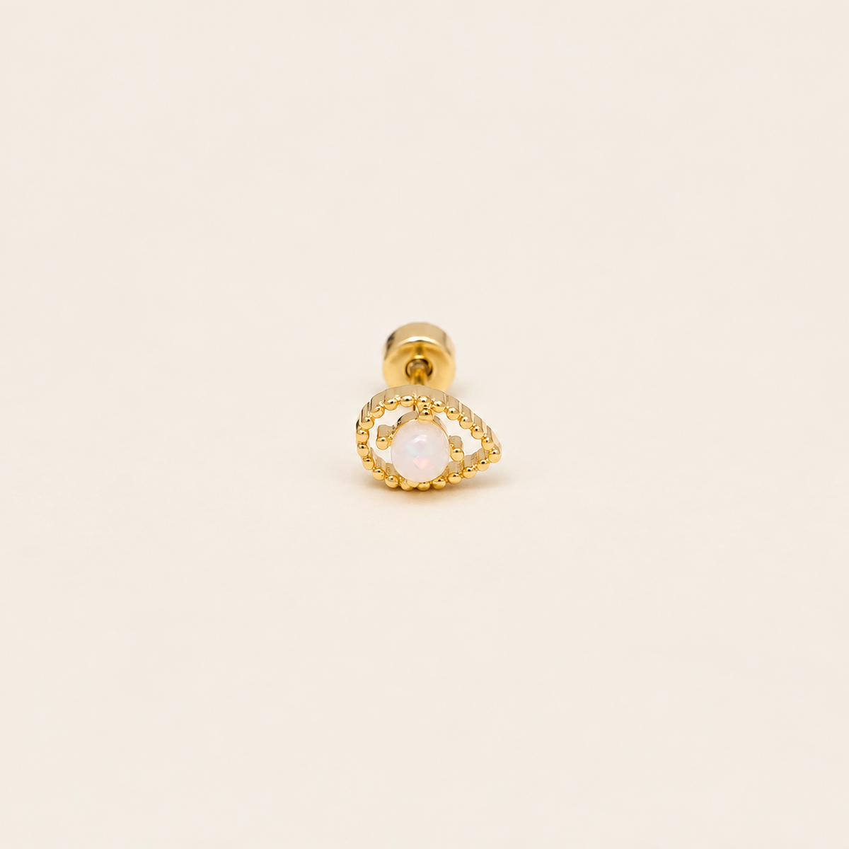 Gold-Tone Iridescent Eye Stud — warm ivory background