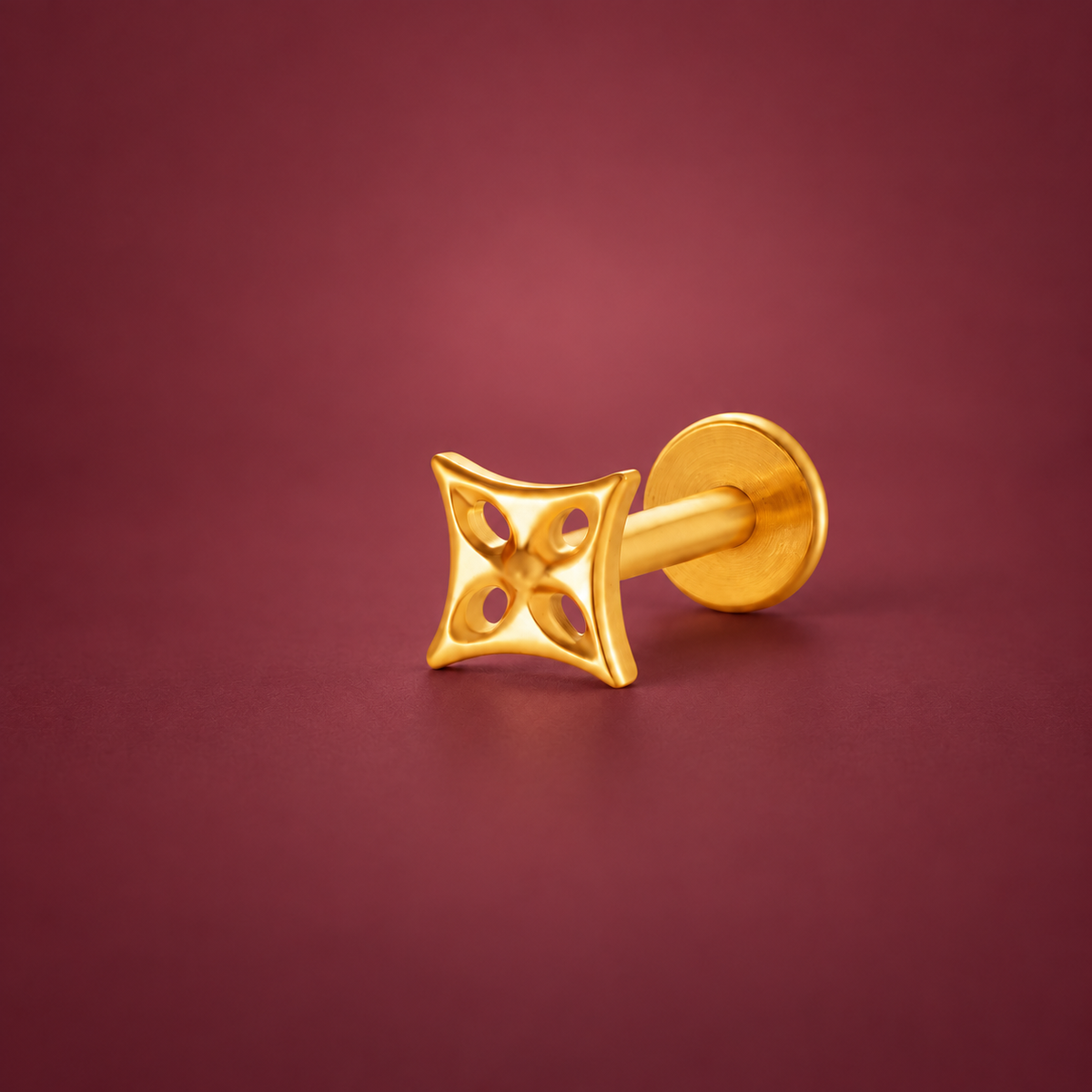 Gold-Tone Geometric Cartilage Stud — muted burgundy background