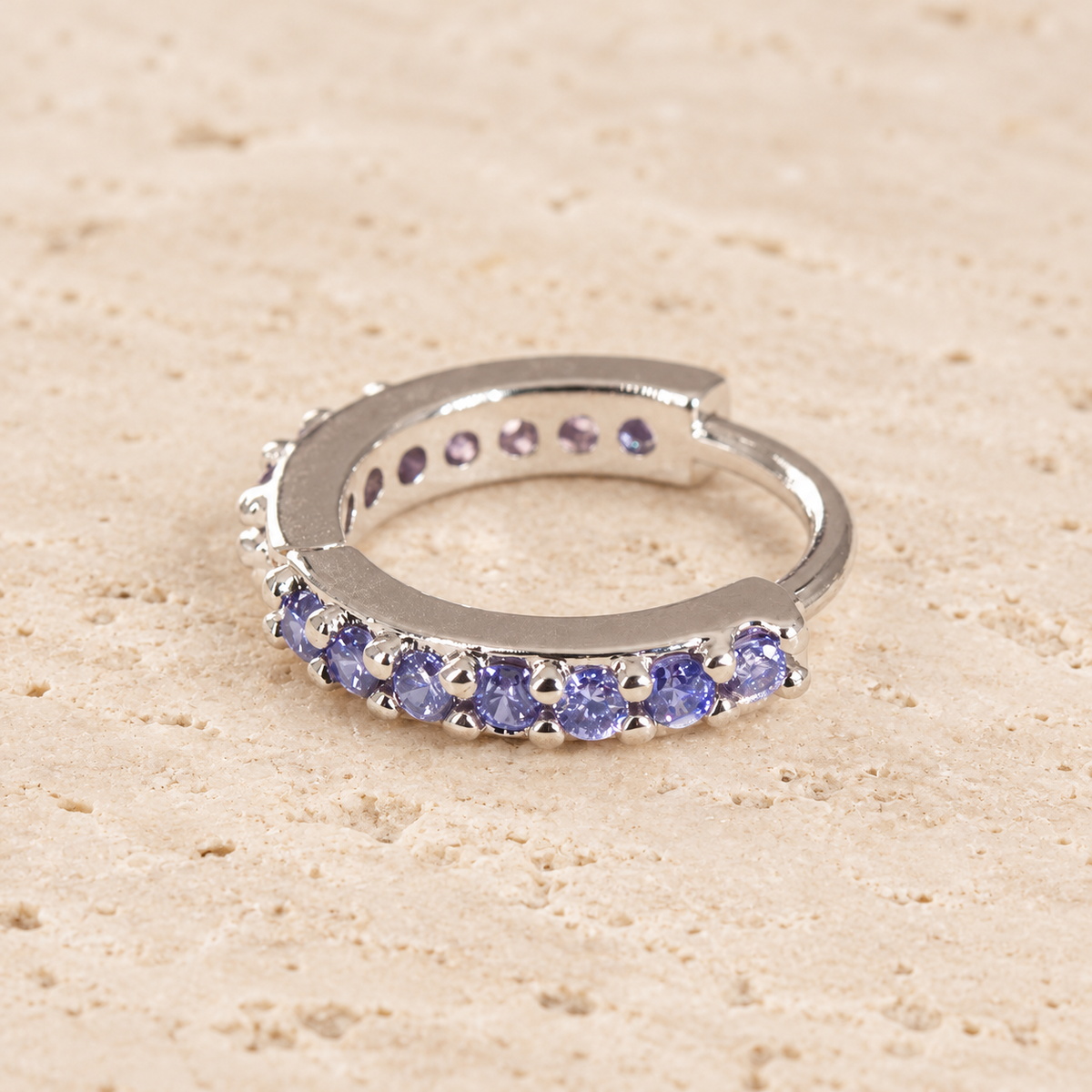 Purple Crystal Ear Cuff — pale beige natural stone background