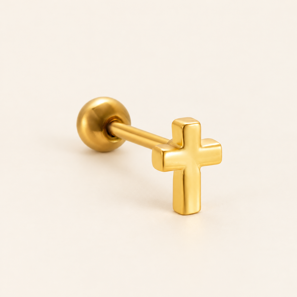 Gold Cross Ear Stud — warm ivory background
