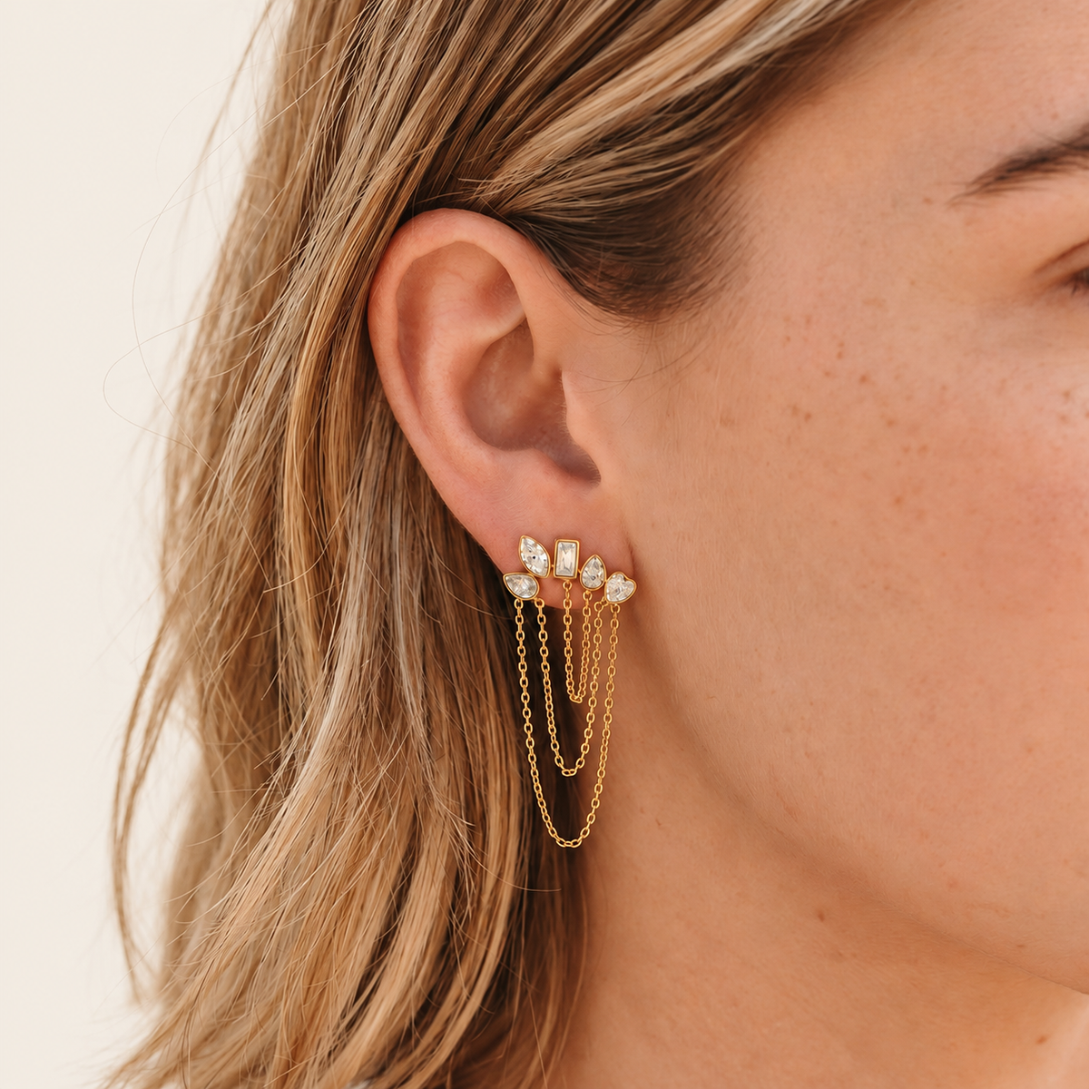Gold Crystal Cascade Earring — warm ivory background