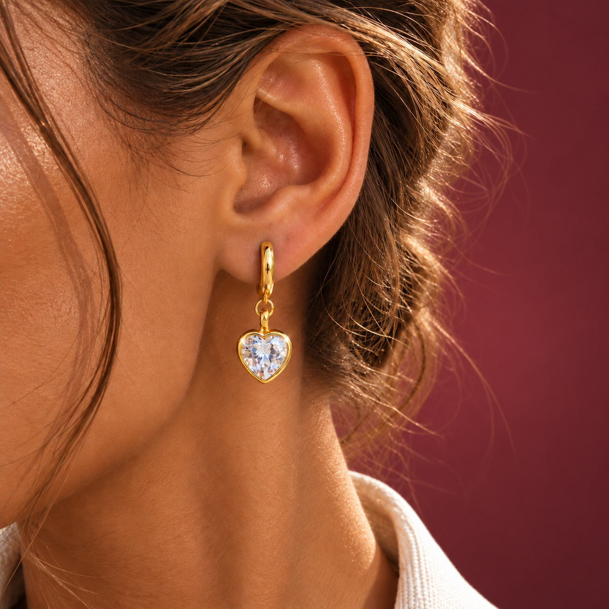 Gold-Tone Crystal Heart Drop Earring — muted burgundy background