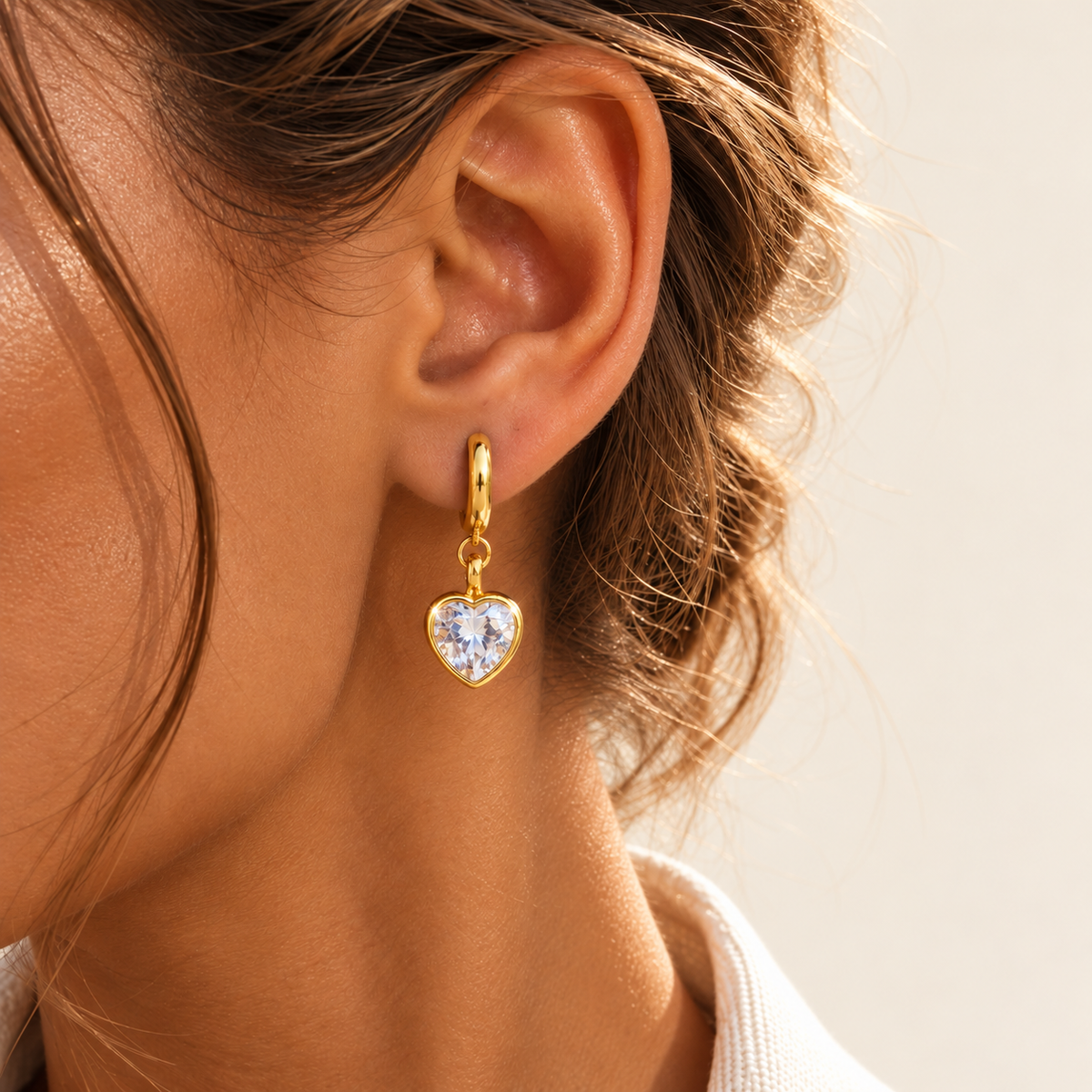 Gold Crystal Heart Drop Earring — warm ivory background