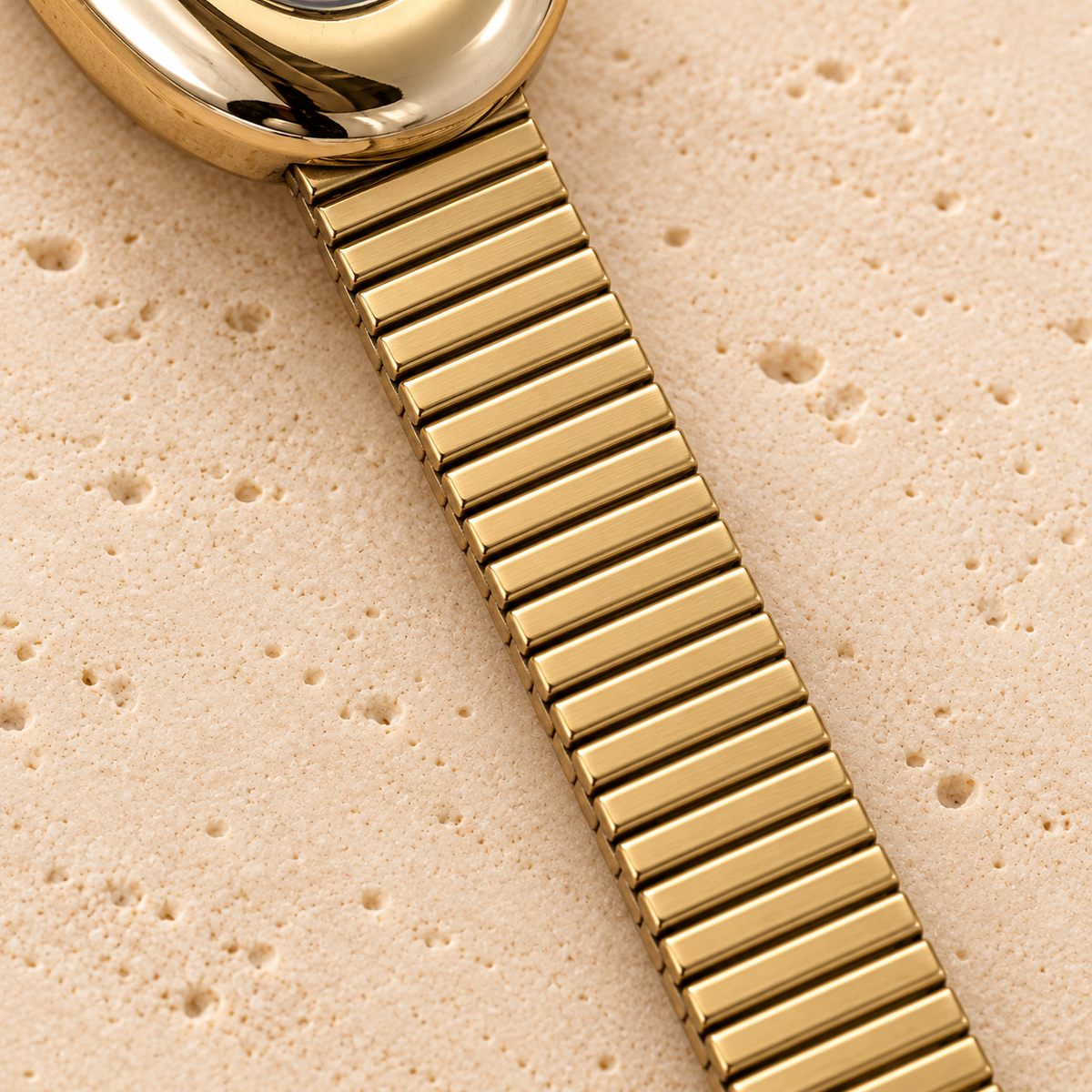 Garnet Oval Flex Watch — bracelet detail — pale beige natural stone background