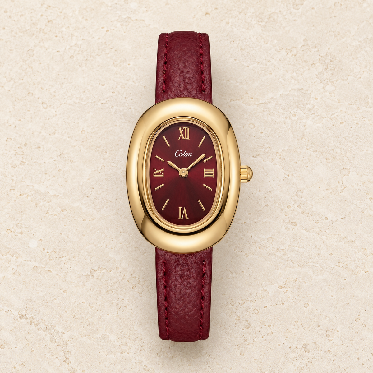 Bordeaux Oval Strap Watch — pale beige natural stone background