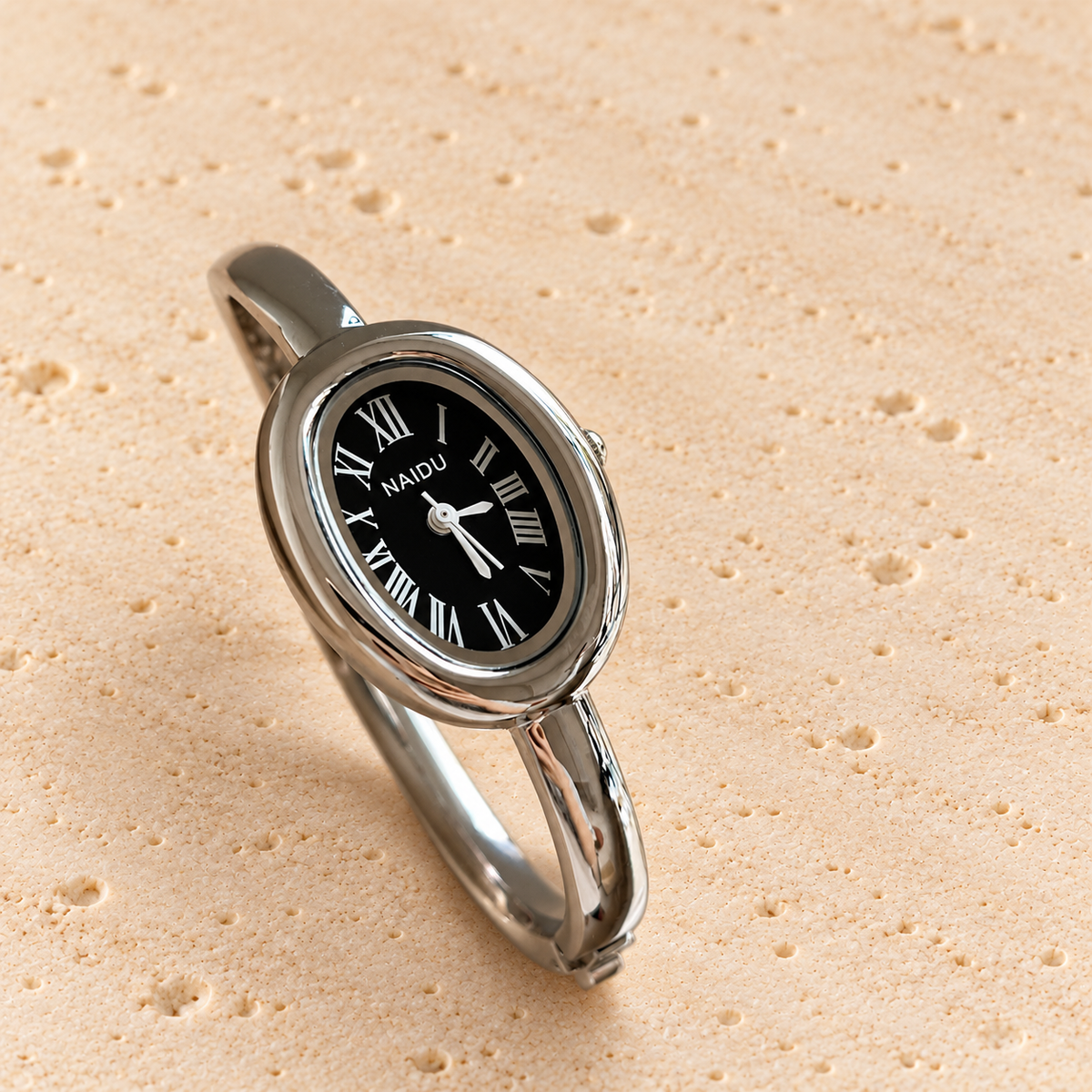 Luna Oval Silver Cuff Watch — pale beige natural stone background